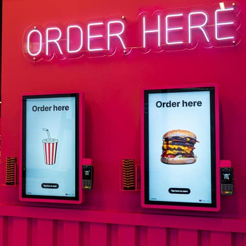 Two Onesix Kiosk Premium Wall ordering kiosks side by side