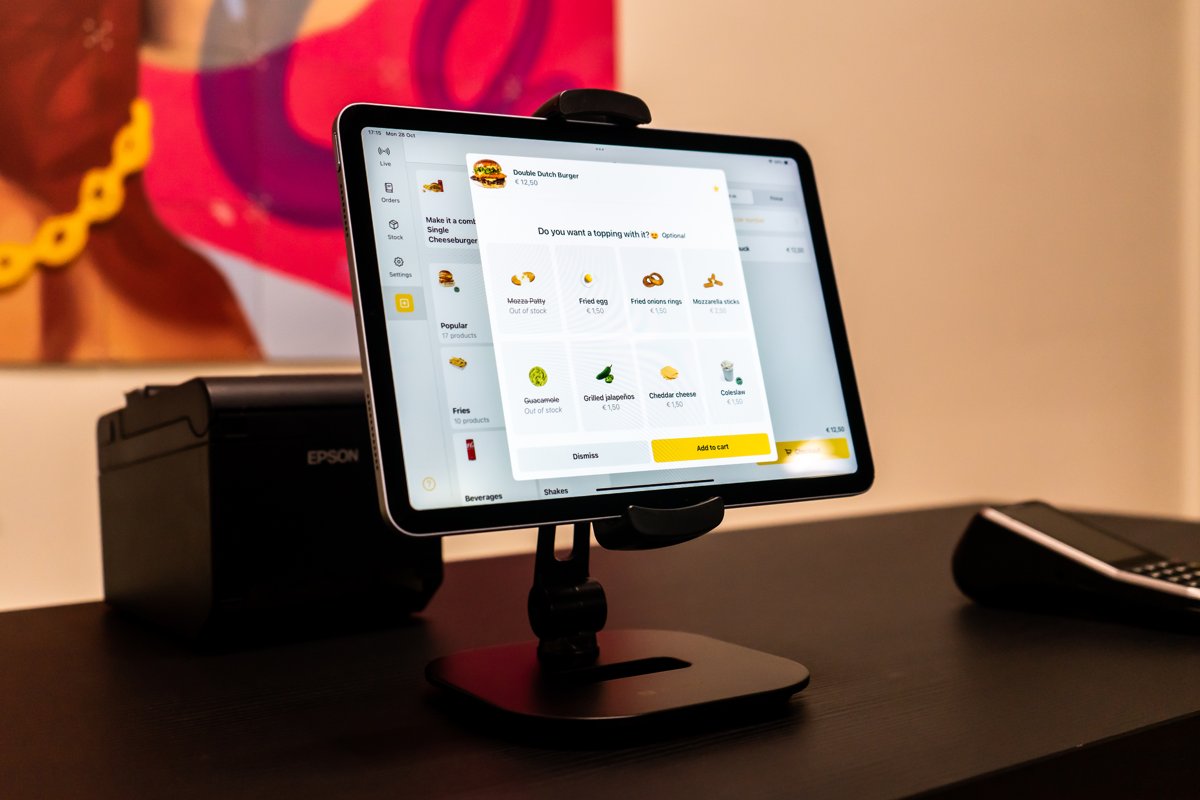 Onesix POS on a tablet showing an upsell screen, next to a receipt printer and a payment terminal