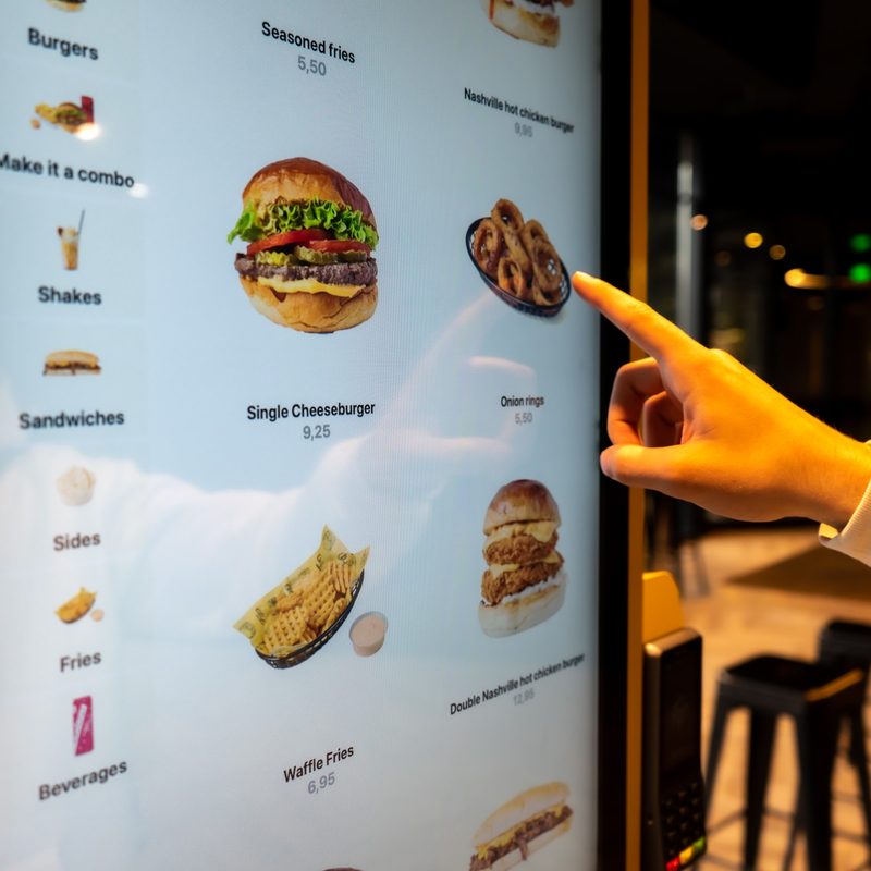 Guest adding an extra on the Onesix Kiosk Premium X at Fat Phill’s