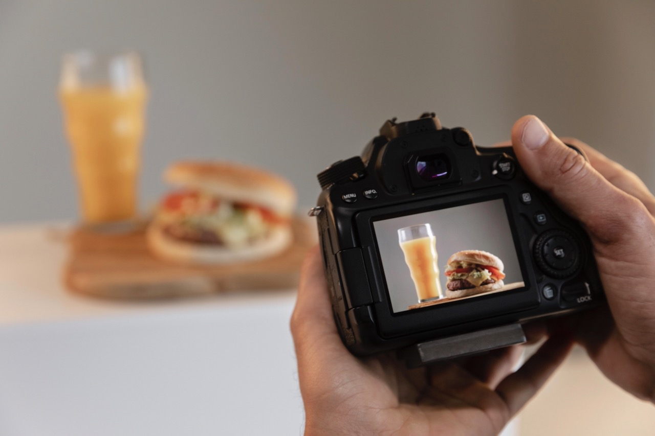 Photo shoot of a hamburger with a drink.